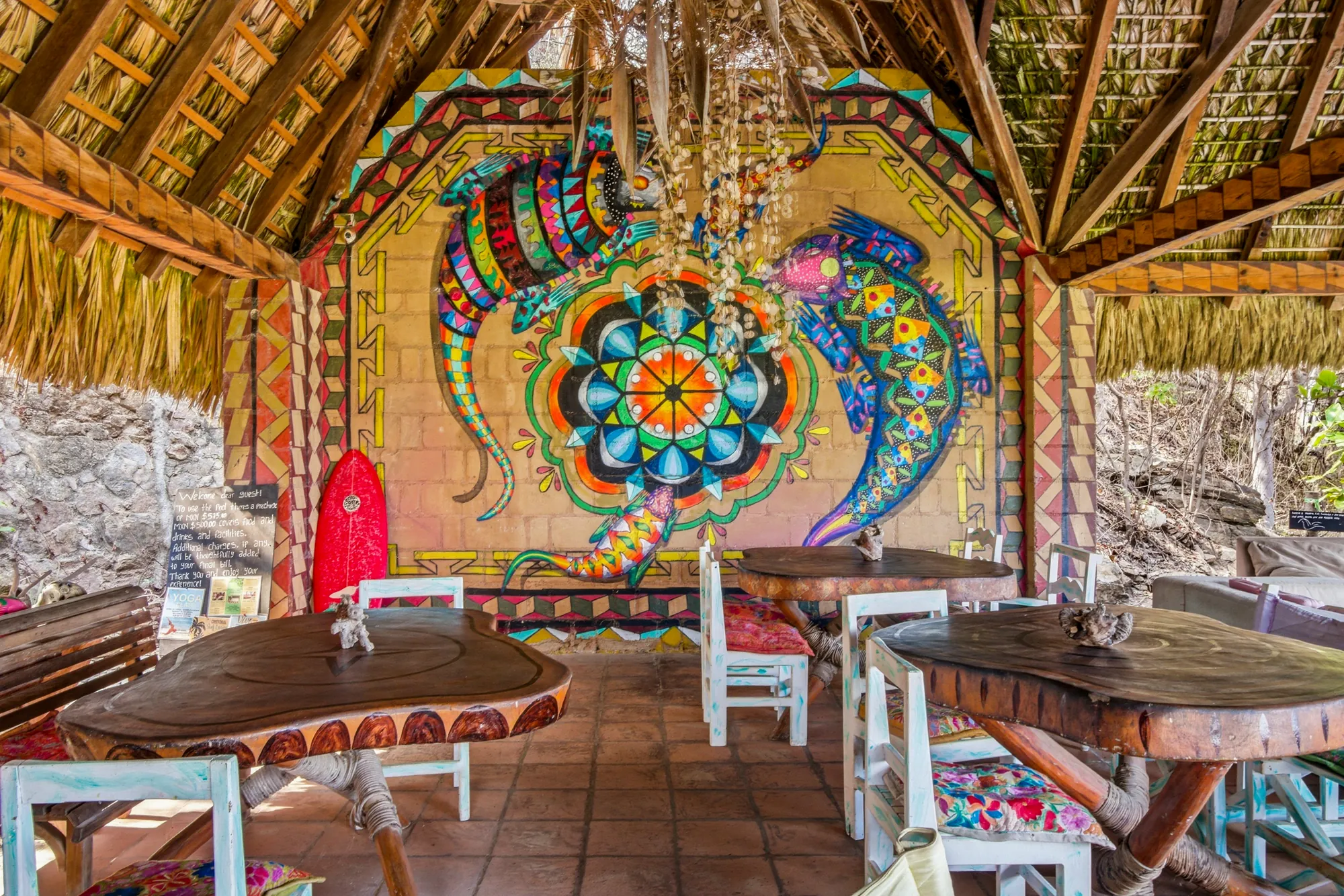 Open-air palapa dining with Oaxacan mural
